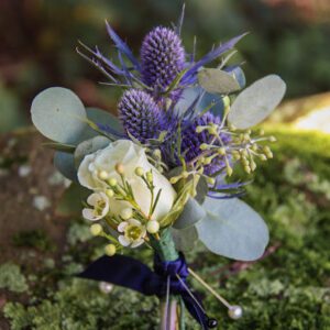 How do you take photos of the boutonniere made with fresh florals designed by a floral designer in natural light?