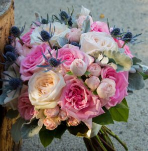A lovely pink bridal bouquet arrangement is made with floral recipe management tools that maximize profit and outcome. You can see how well it is photographed with a clean camera lens by a florist