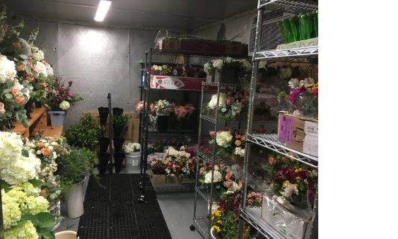 Florist Manages Cooler Space With Rack On Wheels And Bench